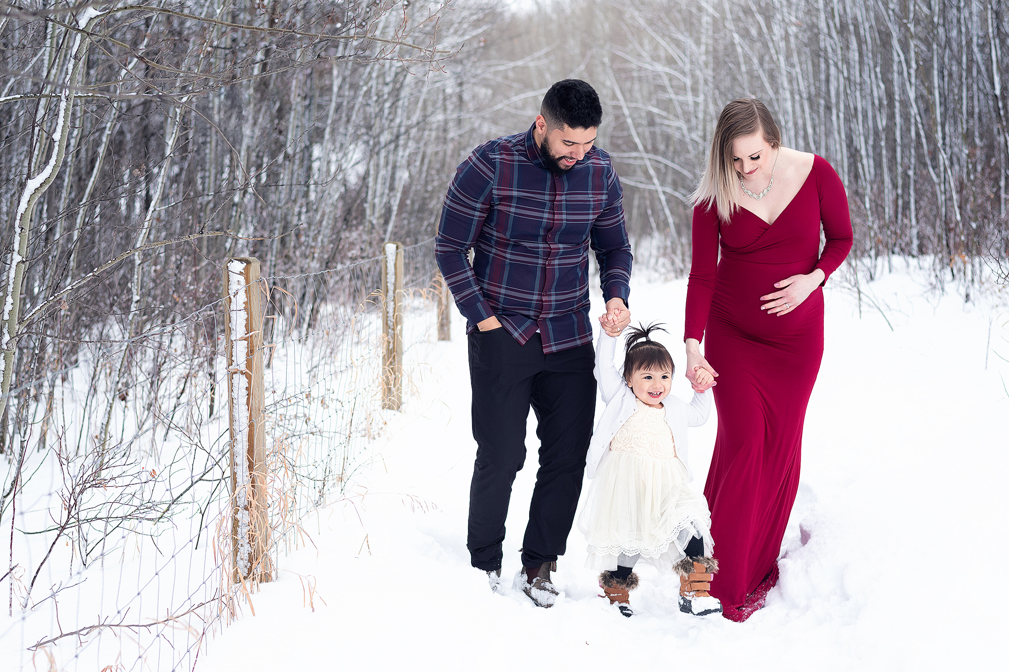 family walking snowy tree lined path maternity family photos leduc county ab