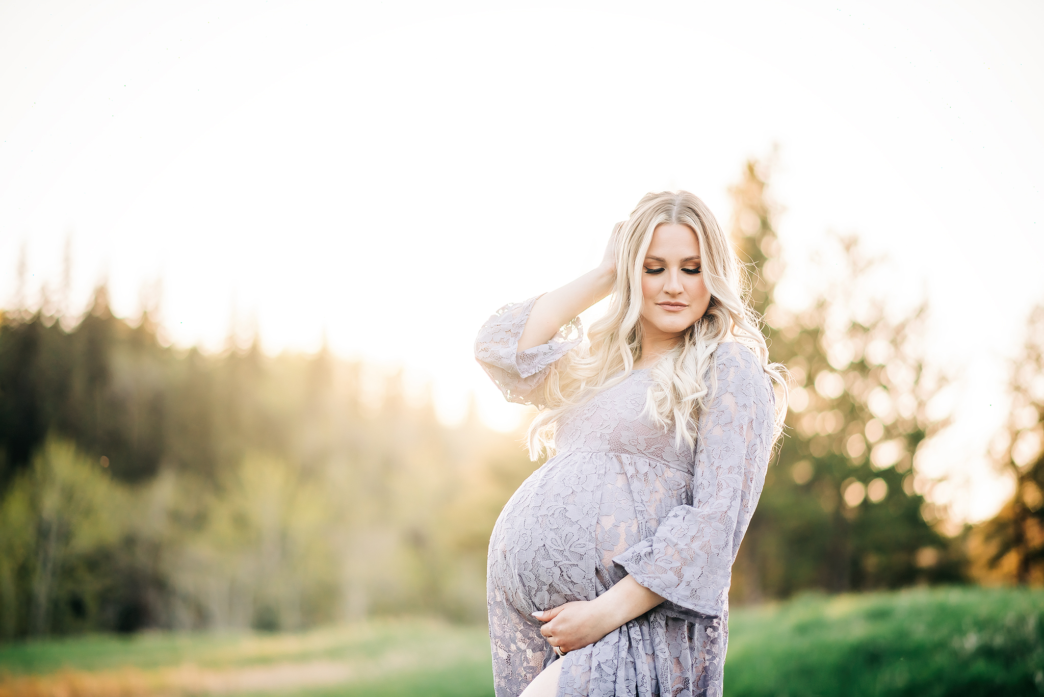 expectant mother embraces baby bump golden hour maternity photo session edmonton ab