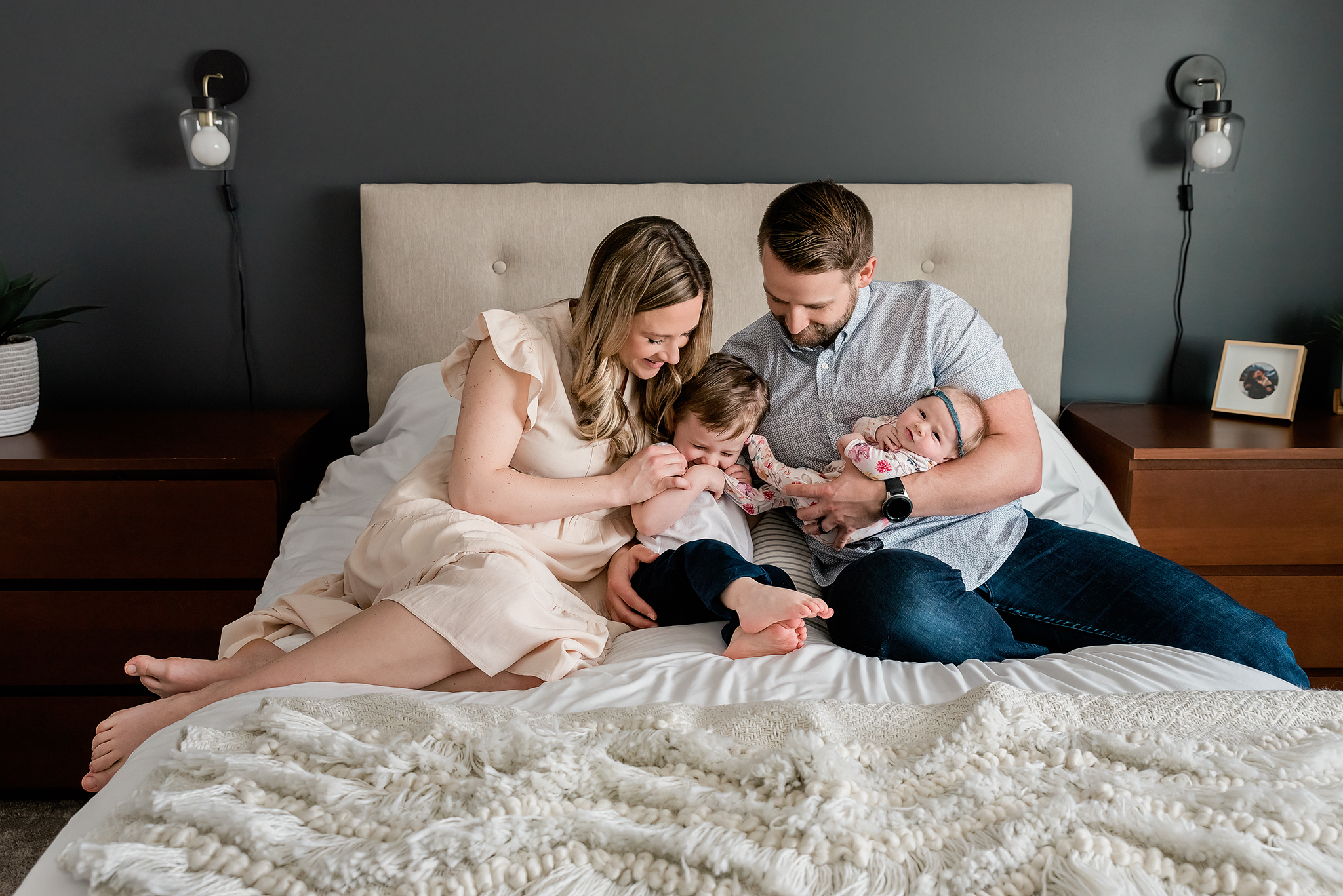 Family of four tickle fight master bedroom in home lifestyle newborn session sherwood park Alberta