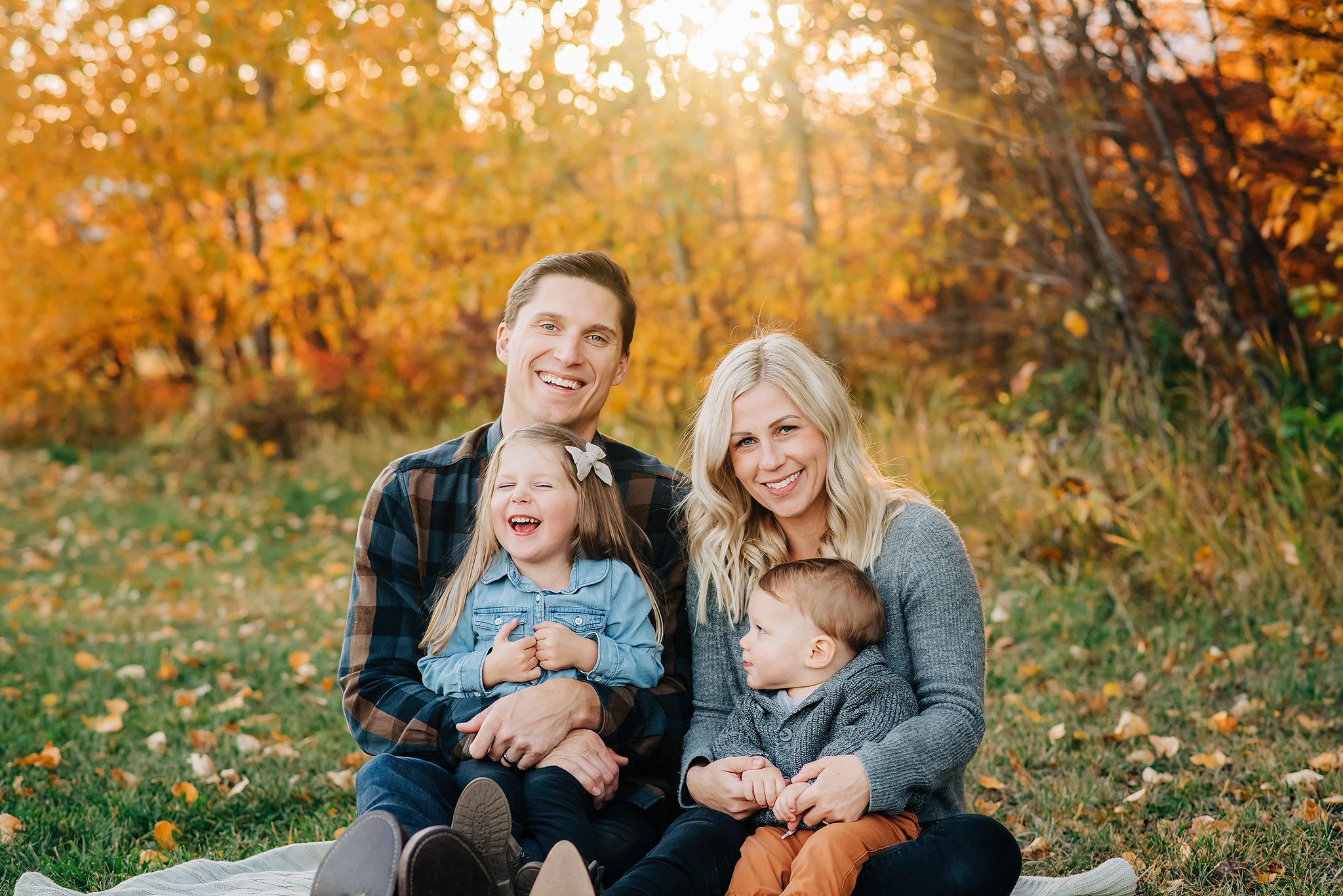 Young family sitting laughing fall family photography session edmonton Alberta