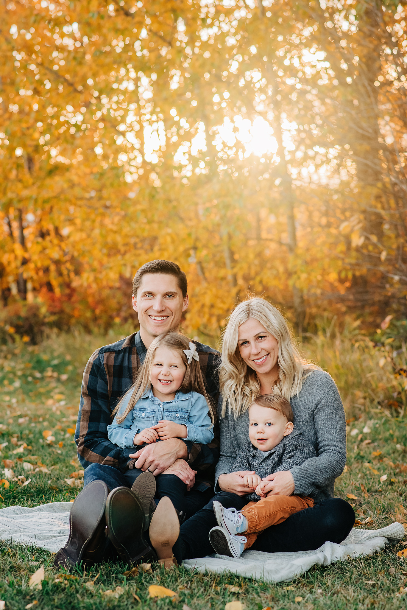 young family sitting laughing fall family photography session edmonton ab