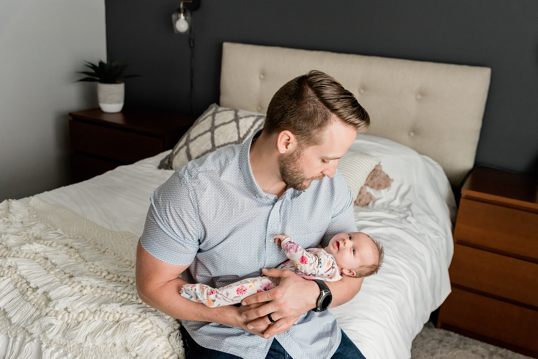 dad holding newborn baby girl in his arms baby smiling lifestyle newborn session strathcona county ab