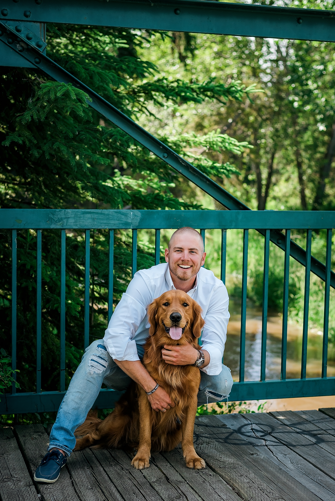man and golden retreiver on bridge extended family photos edmonton